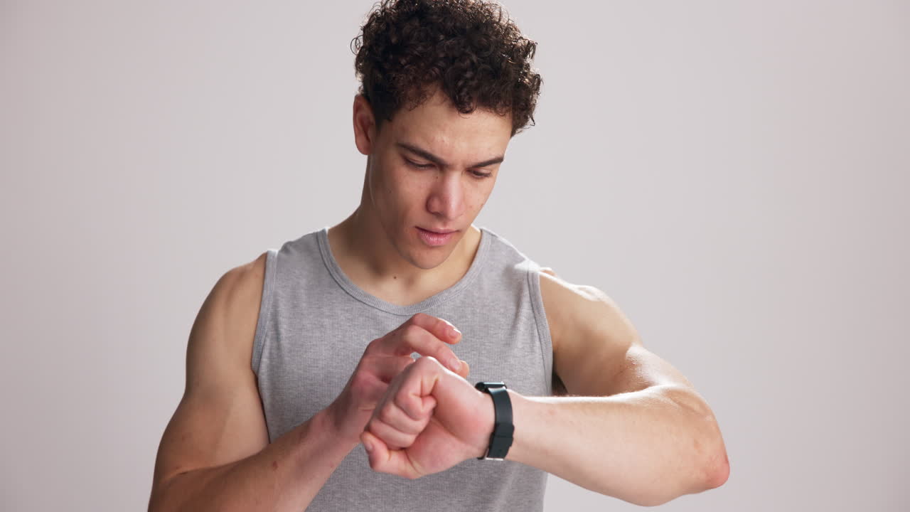Frustrated Young Man Checking Smartwatch with Disappointed Expression