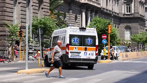 ambulance maneuvers through pedestrians and traffic