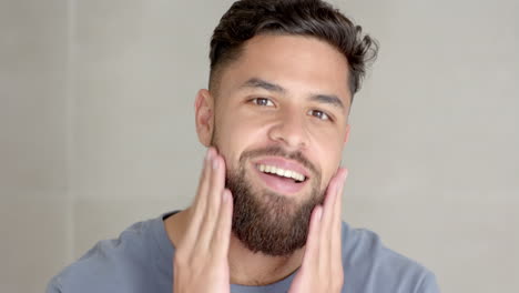 man grooming beard with hands, focusing on personal care and hygiene