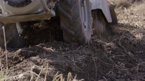 rototiller blades and wheels, working the land in sweden, agriculture, close up