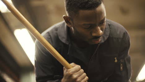 janitor dancer looks down as he mops, slow motion close up