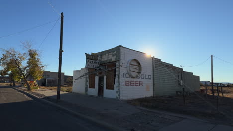 a small roadside building offering pizza and beer.