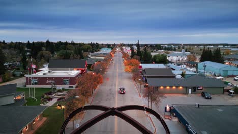 a slow reveal wide angle drone shot of the northern canadian landscape a small rural town skiing fishing village main street arches in asessippi community in binscarth russell manitoba canada