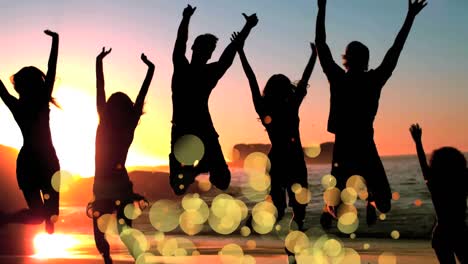 friends jumping on the beach surrounded by bokeh effect