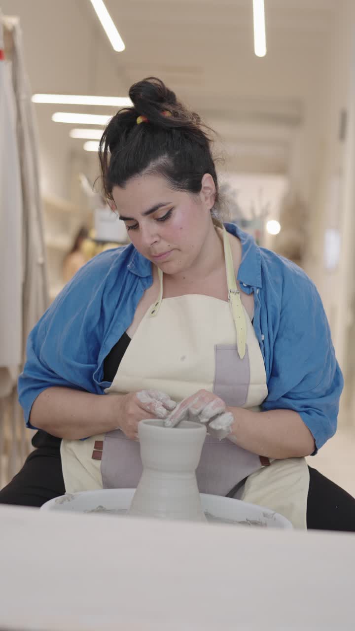 Woman Creating Pottery in Studio