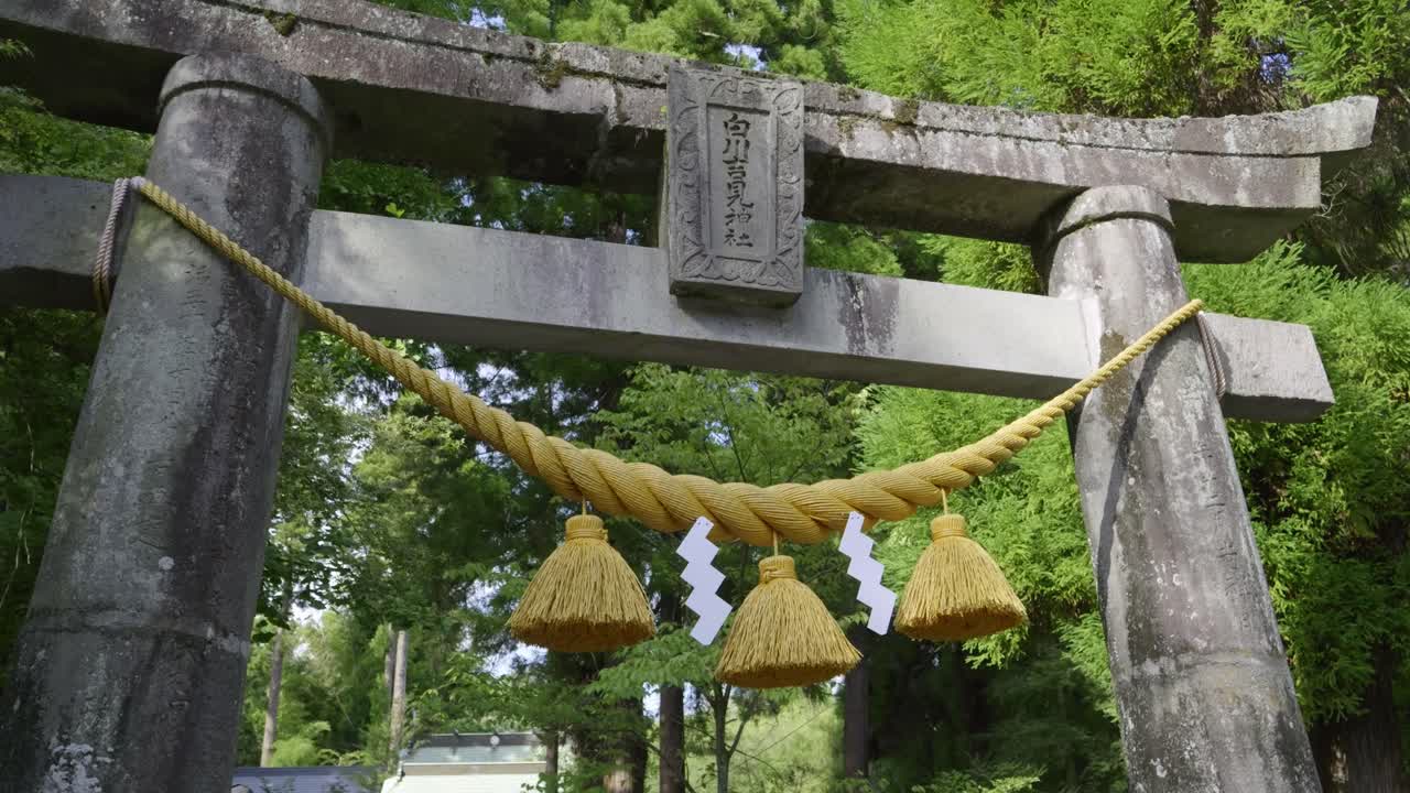 Beautiful cinematic push in toward torii gate at Japanese shinto shrine
