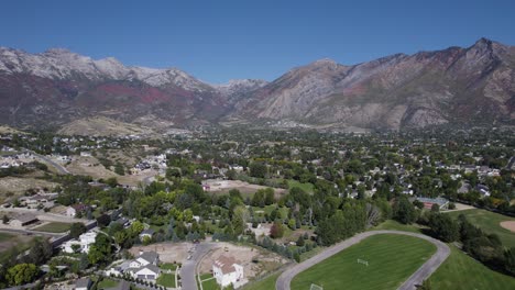 High-angle-drone-panning-shot-of-autumn-colored-mountain-sides-in-Utah-on-a-sunny-day