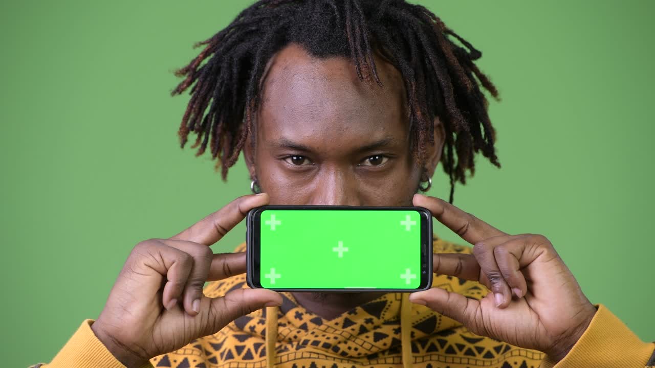 Ung flot afrikansk mand viser telefon