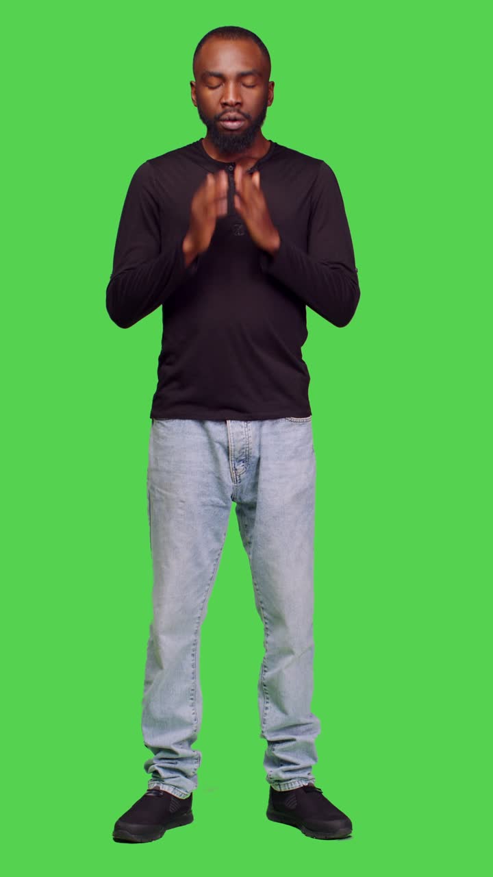 Vertical video: Front view of young adult feeling tired and yawning on camera