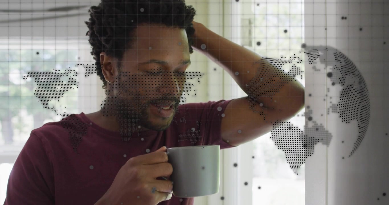Man lifting gray mug while sipping drink and activating animated world map overlay in tech showcase