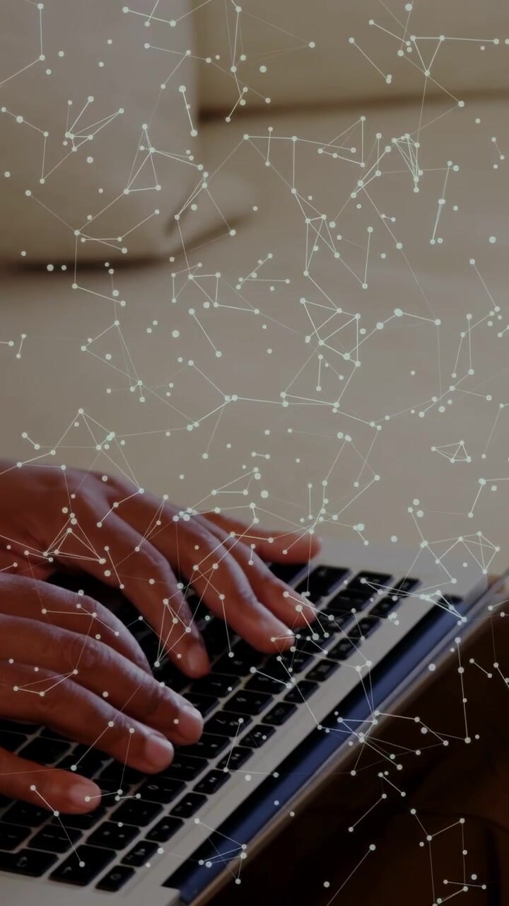Vertical video: Man placing hands on laptop, typing with constellation overlay for tech demo