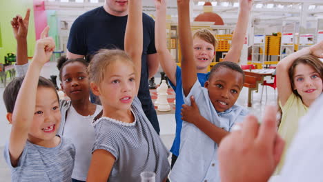 kids volunteering to answer teacher at science centre