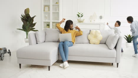 two cheerful kids running in circles and rounds in living room