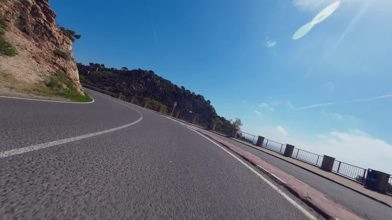 POV shot of a cyclist riding at high speed along a coastal road in Catalunya, Spain