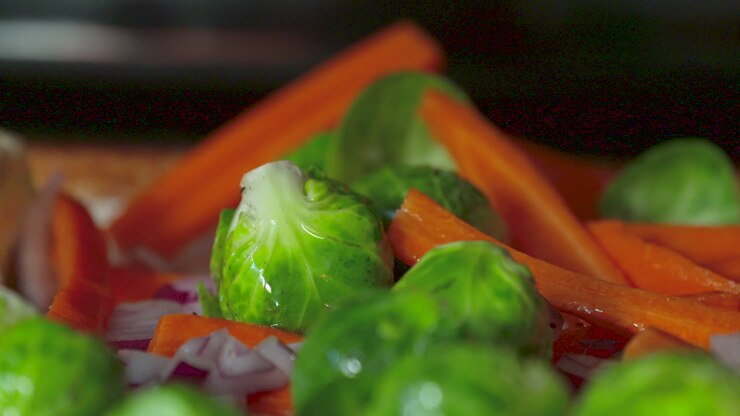 Pouring oil over fresh vegetables before cooking