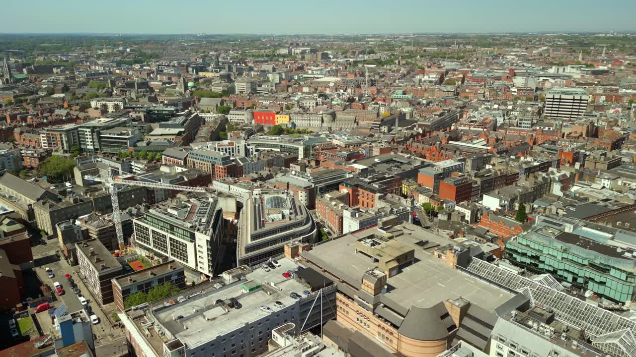 Ultra-wide, forward travelling aerial of the Dublin City skyline in Dublin, County Leinster, Ireland on a bright and sunny day. Filmed in 4K, 60FPS and with Rec709 color.