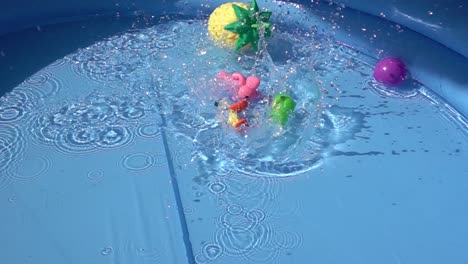 toys falling and floating in a pool