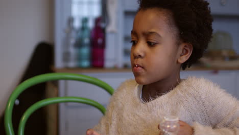 girl eating homemade cupcakes at table shot on r3d