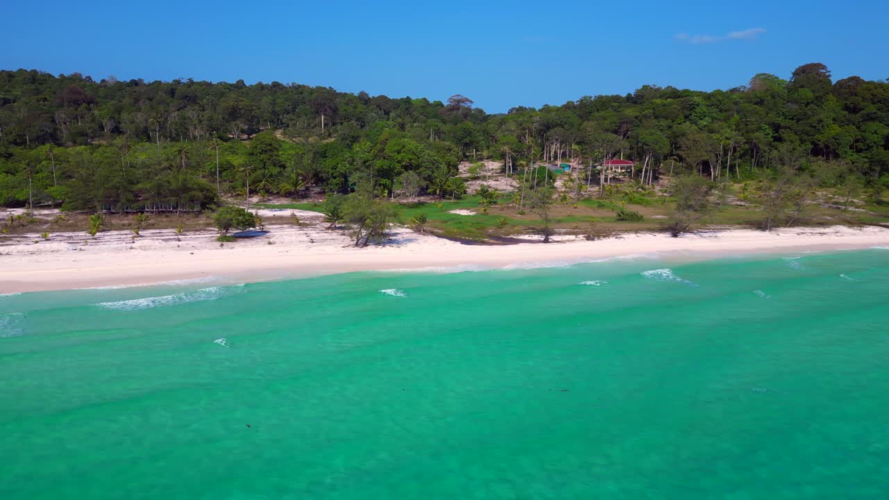 Tropical landscape showing turquoise sea washing white sand beach and green rainforest covering Koh Rong island in Cambodia. Wonderful aerial view flight panorama overview drone