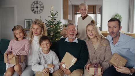 caucasian man preparing camera to make a photo with family in christmas time.