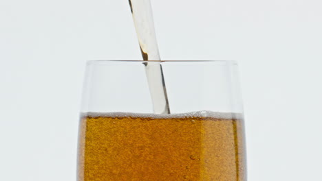 refreshing beer pouring glass closeup slow motion. liquid filling clean goblet