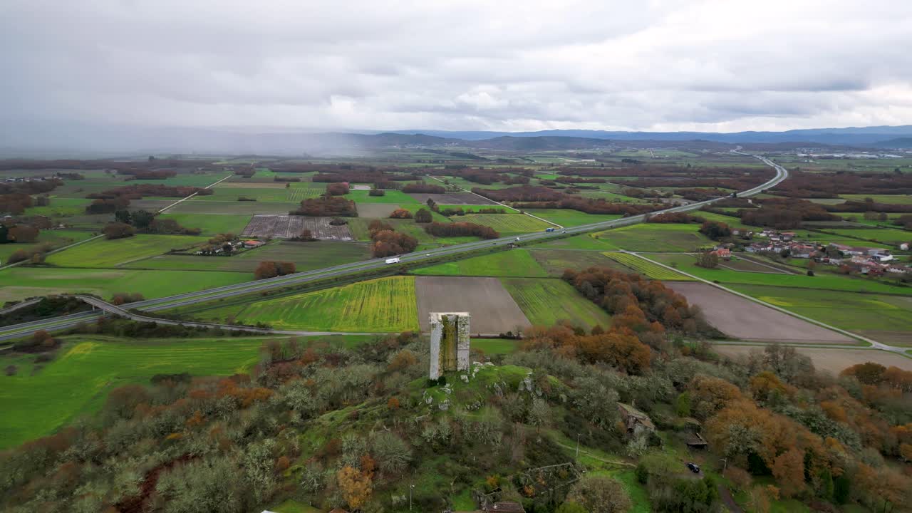 Sandi&aacute;s tower near highway in ourense, spain, aerial orbit, cloudy day