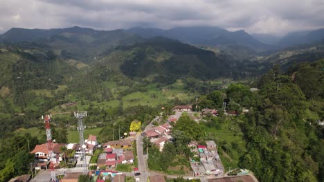 drone flyover salento toward lush forested valley on colombian mountains, colombia