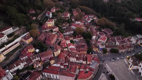 Aerial-cinematographic-drone-shot-circling-around-the-ancient-town-of-Sintra-and-revealing-the-beautiful-old-houses-of-Lisbon,-Portugal