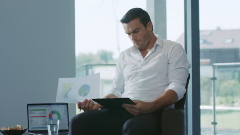 Business-man-sitting-with-notebook.-Professional-working-with-chart-documents.