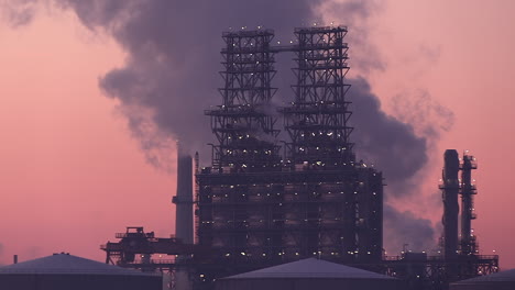 a crane at work at a petroleum refinery at dawn, port of antwerp