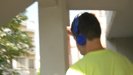 man in headphones walking downstairs