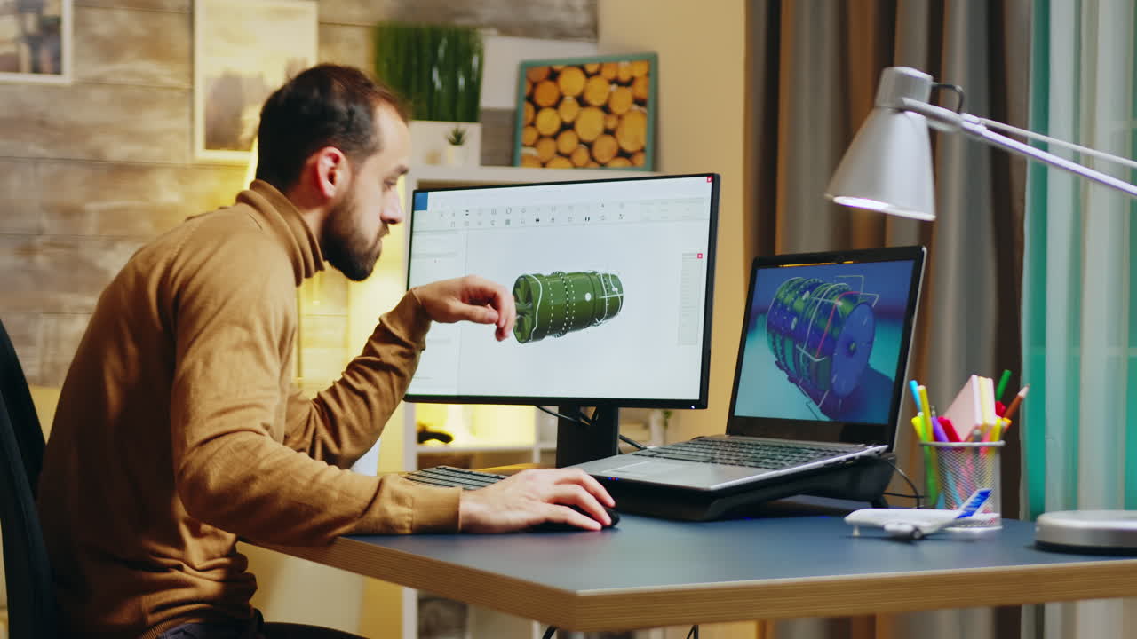Bearded engineer sitting at his desk in home office