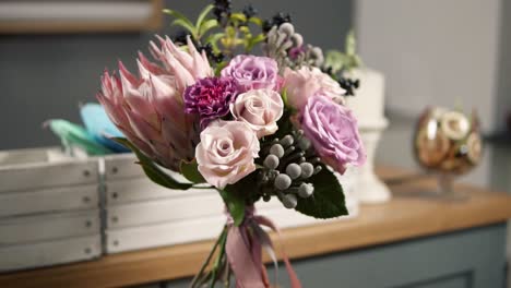 Camera-round-movement:-beautiful-fresh-bouquet-in-the-flower-shot:-floral-composition-consists-of-Rose,-Brunia,-Protea-with