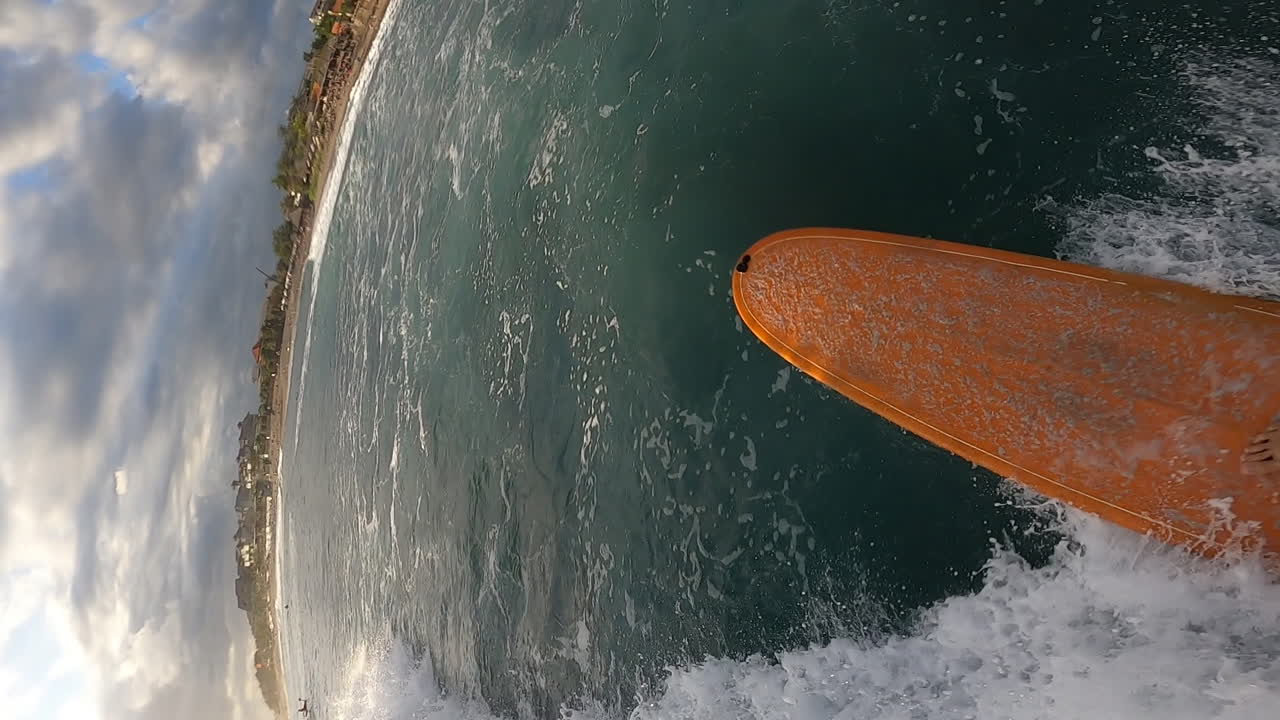 hombre surfeando en la ola del océano en la tabla de surf en la playa tropical, pov vertical