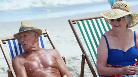 Amigos-Mayores-Sentados-En-Una-Silla-De-Playa