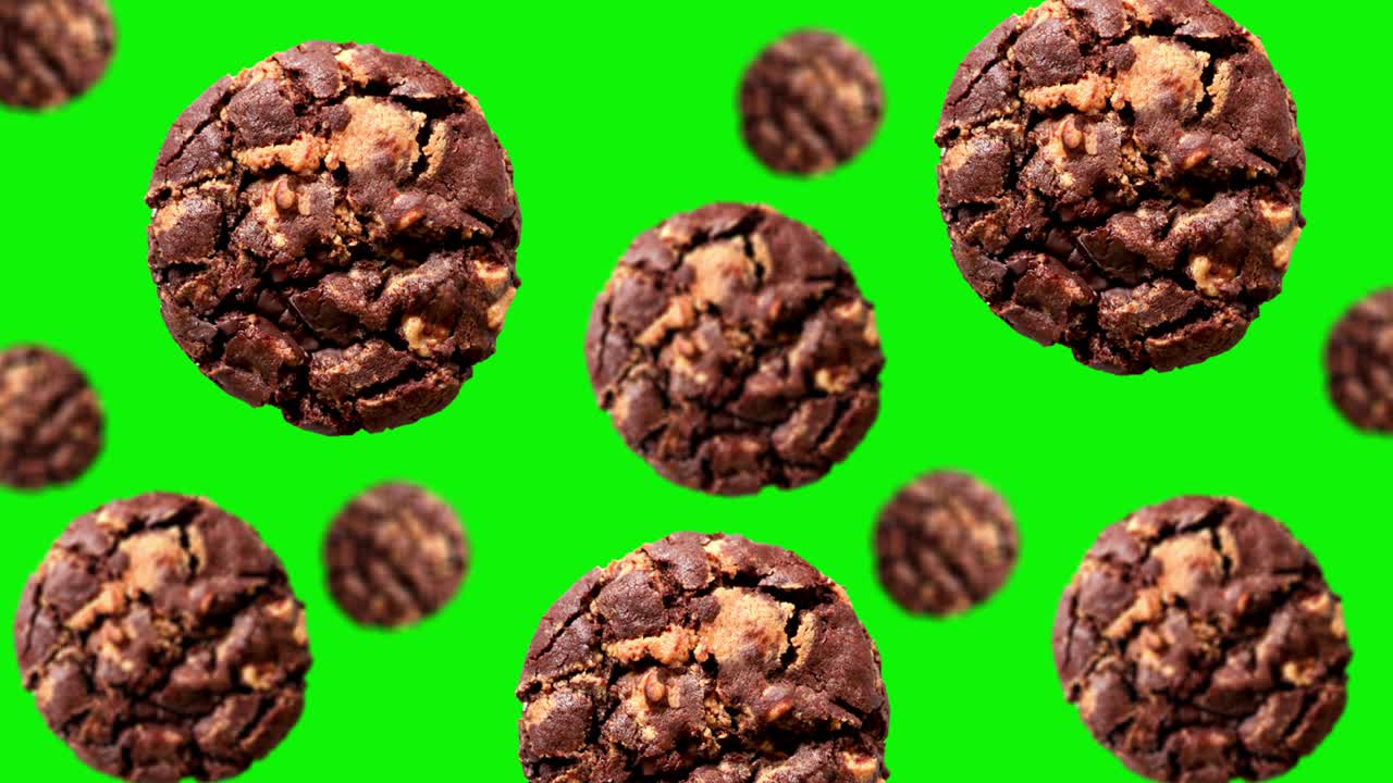летающее печенье с темным шоколадным чипом различного диаметра на зеленом экране на изолированном фоне. движущийся фон. анимированный фон. высококачественные 4k рождественские сладости.