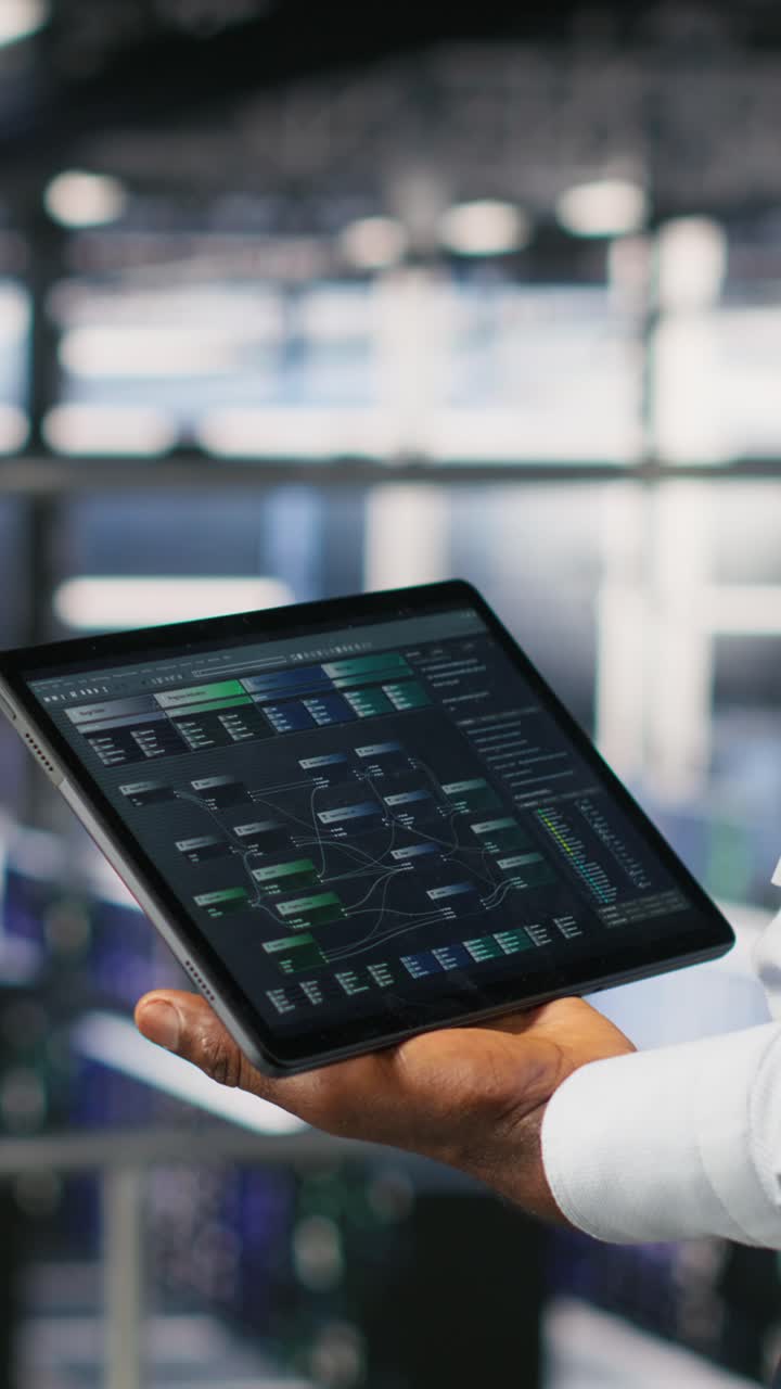 Vertical video Close up of data center admin using tablet to reviewing machine learning code