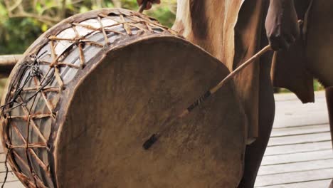 zulu tribesman hitting on a drum during traditional ritual