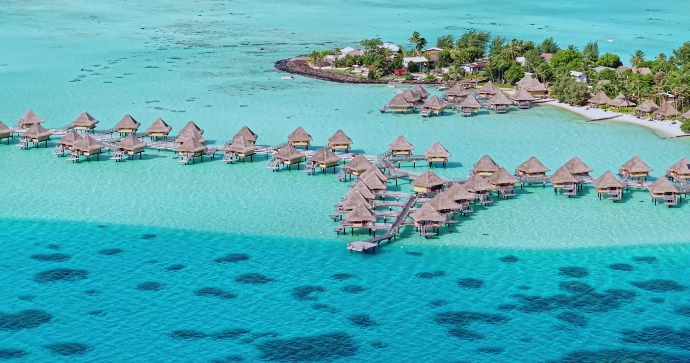 Drone Shot of Bora Bora Island Luxury Resort, French Polynesia, Bungalows Over Turquoise Water and White Sand Beach