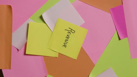 business concept of revolving sticky notes with revenue written on top note