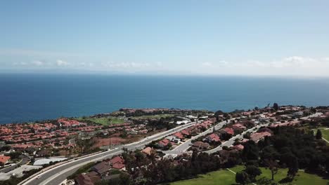 Palos-Verdes-California-Aerial-view-road-blue-water-blue-sky-trees-and-greenery-scenic-shot-of-luxury-homes