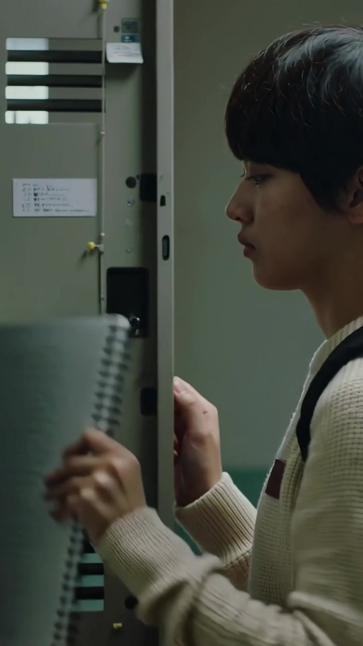 Vertical video: Reaching locker, teen taking item in school hall, teal backpack, copy space