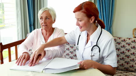 Nurse-helping-patient-reading-in-braille