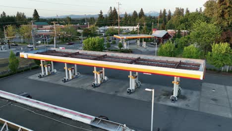Aerial-view-pulling-away-from-a-vacant-gas-station-in-America