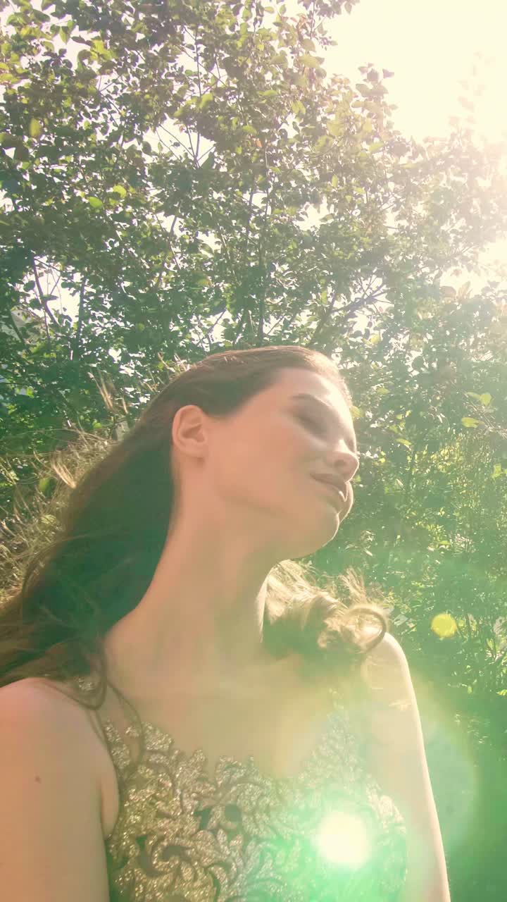 Woman in a golden dress in a garden