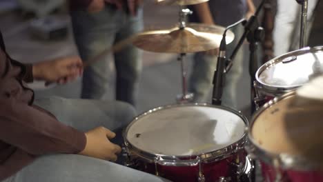 A-woman-playing-on-drum-in-the-theatre-static-shot,-close-up-shot,-insert-shot