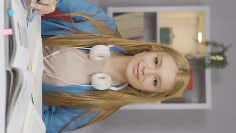 Vertical-video-of-Female-student-waving-to-the-camera.