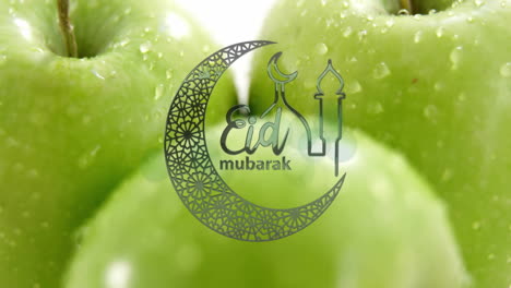 eid mubarak text animation over close-up of green apples with water droplets