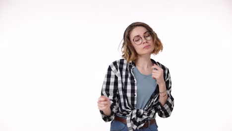 Portrait-of-glad-pleased-woman-listening-her-favourite-song-on-smartphone-dancing-and-singing-while-enjoying-music-with