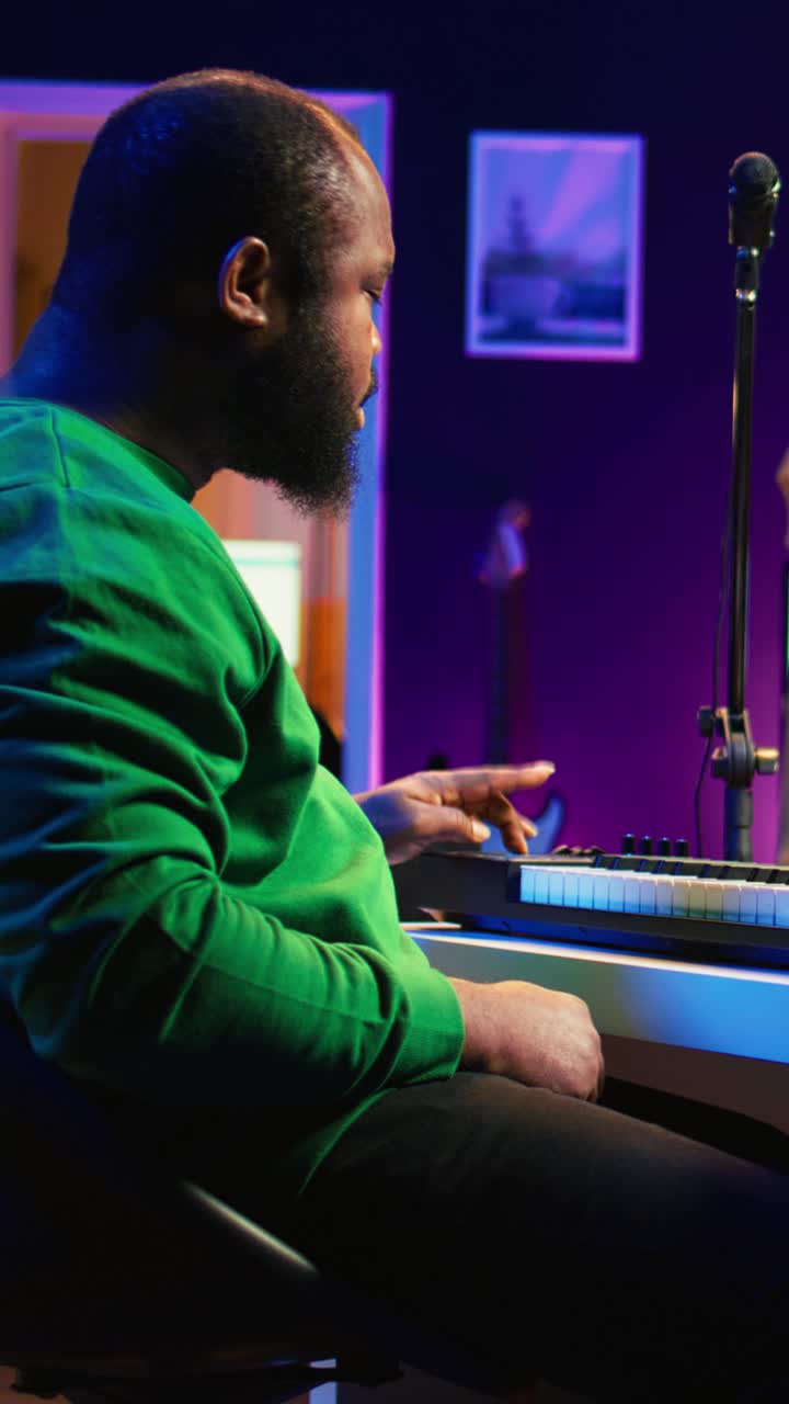 African American Man Playing Digital Piano in Music Studio